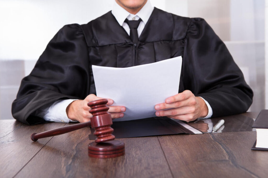 closeup-male-judge-front-mallet-holding-documents